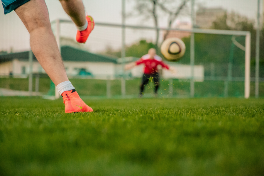 A footballer kicking a ball