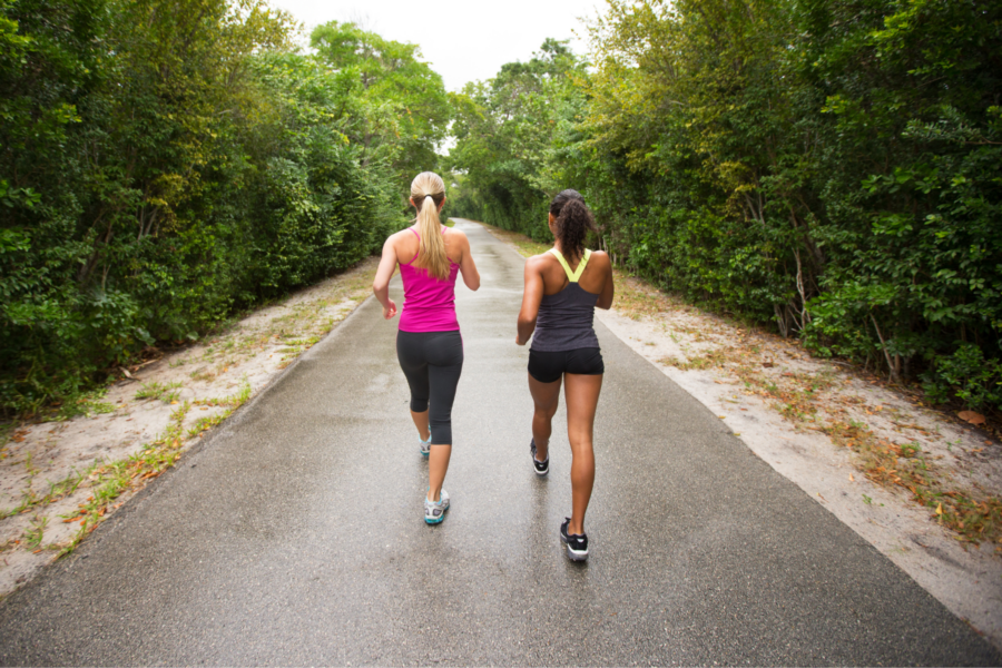 Two women exercising by power walking