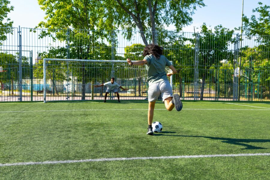 A person kicking a football